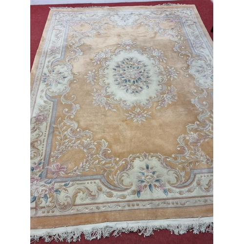 677 - A large  pink ground carpet with central floral design multi floral borders and allover decoration. ... 