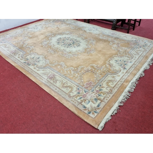 677 - A large  pink ground carpet with central floral design multi floral borders and allover decoration. ... 