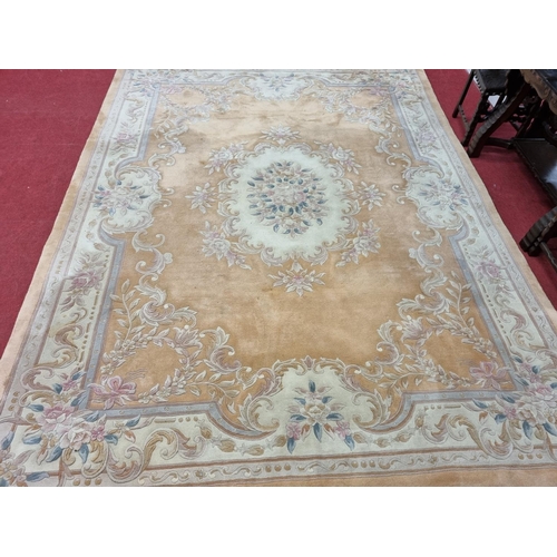 677 - A large  pink ground carpet with central floral design multi floral borders and allover decoration. ... 