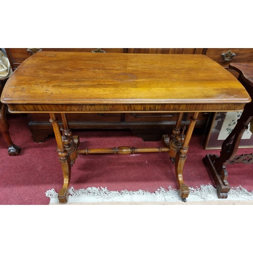 678 - A 19th Century Walnut Centre Table with curved ends turned supports and stretcher base. W 101 x 53 x... 