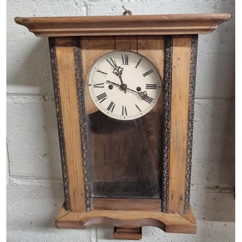 135 - A 20th Century Wall Clock with key and pendulum along with another late 19th Century example. 30 x D... 