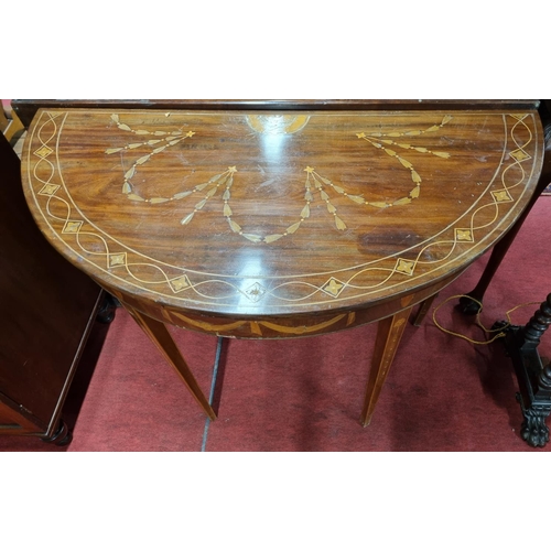 160 - A 19th Century bow fronted Mahogany Side/Serving Table profusely inlaid with bows and swags. 
H 85 x... 