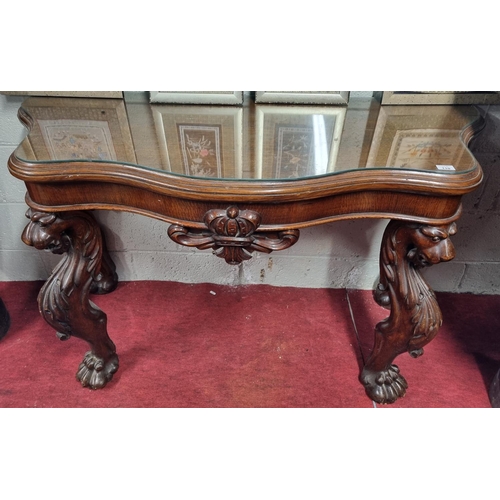 110 - An early 19th Century Oak Irish Console Table with hairy paw front supports highly carved top and se... 