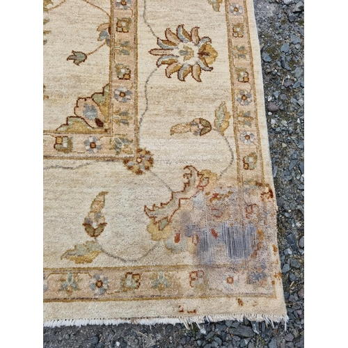 111 - A large cream ground Carpet. L 308 x W 200 cm approx.