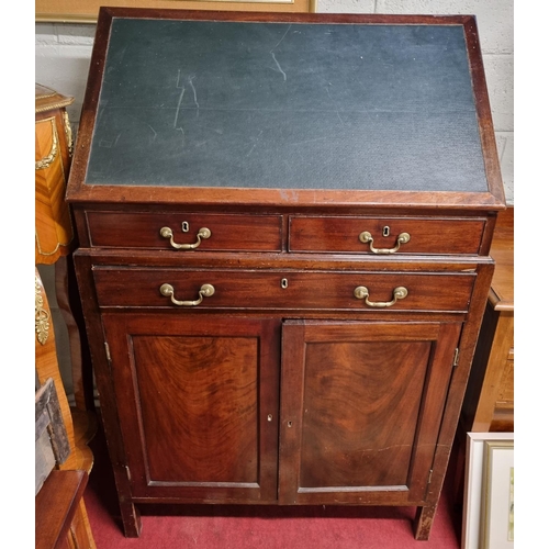 139 - A 19th Century Mahogany Draughtsman's Desk with twin cupboard doors under triple drawers.
H 113 x 93... 