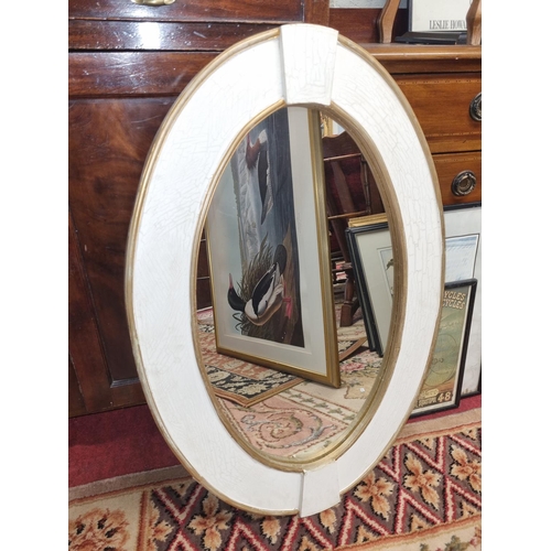 151 - A modern painted oval Mirror. 
H 86 x 60 cm approx.