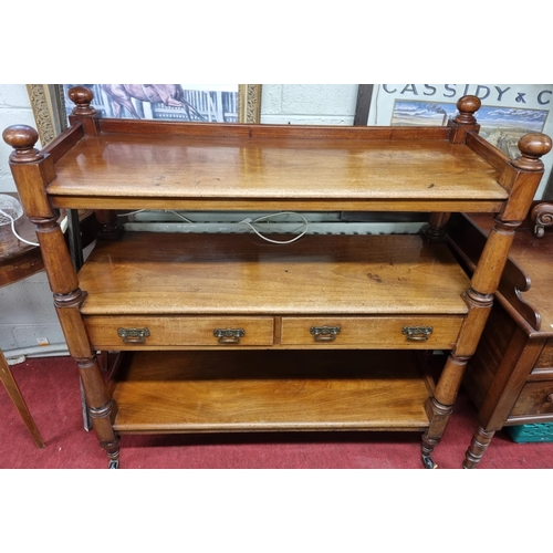 162 - A 19th Century Mahogany three tiered Dumb Waiter with twin centre frieze drawers turned supports and... 