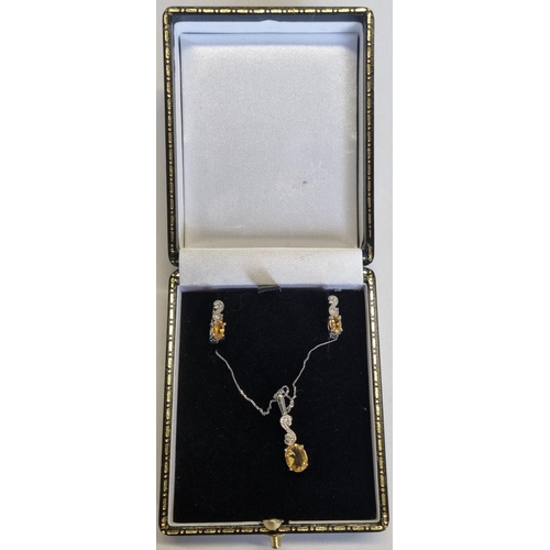 20 - A Gold, Diamond and Topaz Pendant and Earrings.