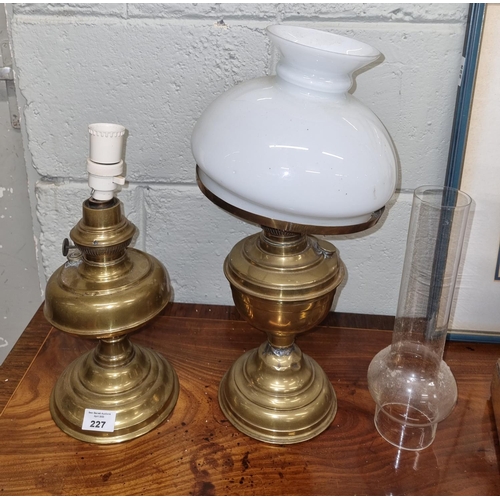 940 - Two late 19th early 20th Century Brass Oil Lamps. One with cloudy shade and funnel.