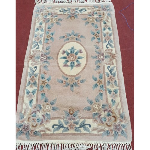 811 - Oriental Style Rug With Pink and Cream Tones. L 152 x W 90 cm approx.