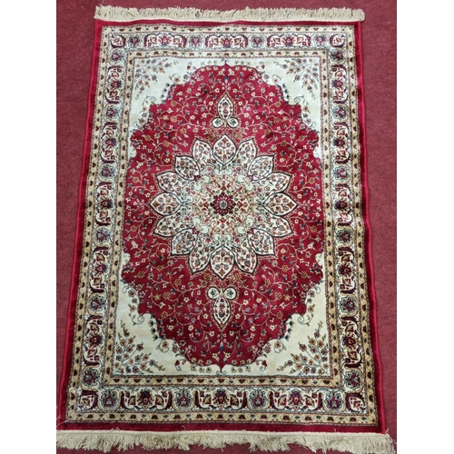 823 - An Red ground Cashmere style Rug. 180 x 117 cm approx.