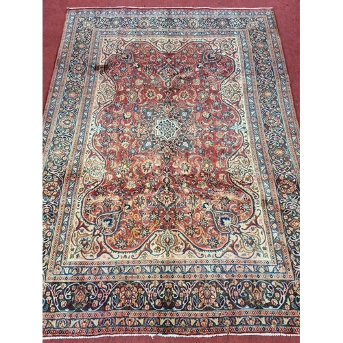 827 - A lovely Terracotta ground Iranian Carpet with central medallion design and a unique border depictin... 