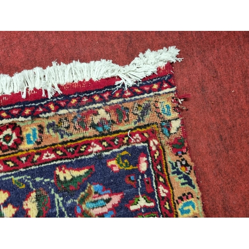 828 - A rich ground Persian Tabriz Carpet with a milticolour ground and a navy blue border. 395 x 270 cms ... 