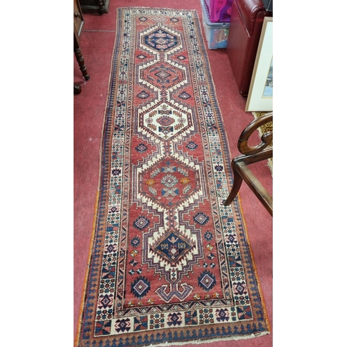 837 - An early Persian Red ground Runner with unique design and multi borders. 
330 x 88 cm approx.