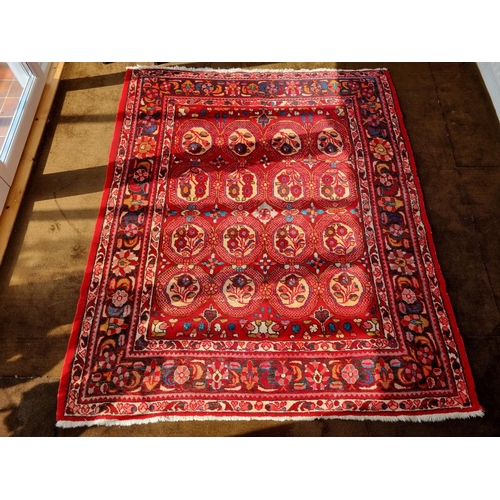 111 - A good red ground Persian Rug with repeating centre decoration and multi borders. L 199 x W 165 cm a... 