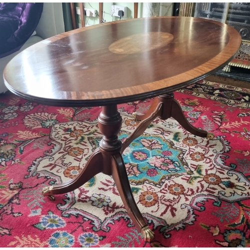 72 - A modern Mahogany Coffee Table with splayed legs and brass castors. H 48 x L 98 x W 57 cm approx.