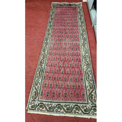 840 - A Persian Pink ground Runner. 293 x 92cm approx.