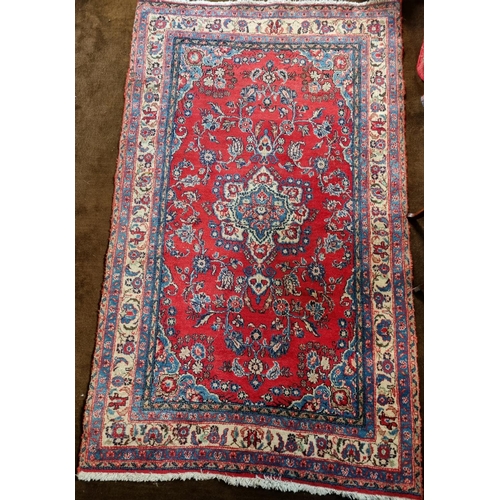 77 - A good Persian red ground Rug with cream and blue borders and central medallion design.
L 198 x W 12... 