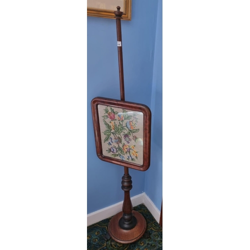 119 - A 19th Century Pole Screen with tapestry panel on platform base. Height 139 cm approx.