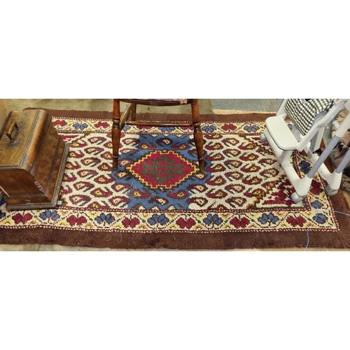 462 - A good Cream and Brown ground Rug with multi coloured centre. 211 x 110 cm approx.