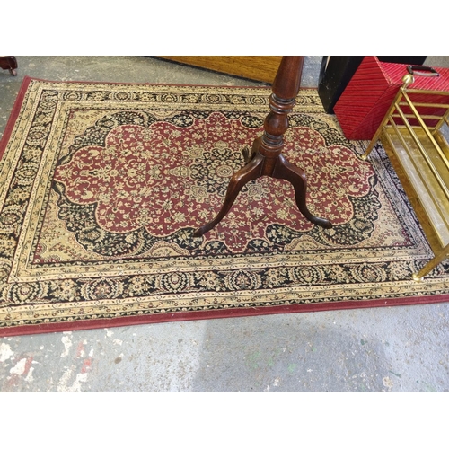 463 - A red ground Rug with multi borders and all over decoration. 120 x 170 cm approx.