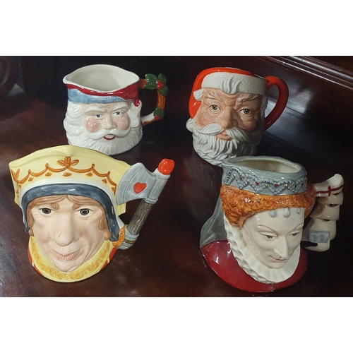 206 - A group of three Royal Doulton mid size Toby Jugs along with another toby of Father Christmas, made ... 