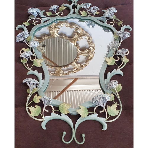 867 - A highly variegated Mirror in shield shape with floral decoration. 94 x 68 cm approx.  ( Bartra Hous... 