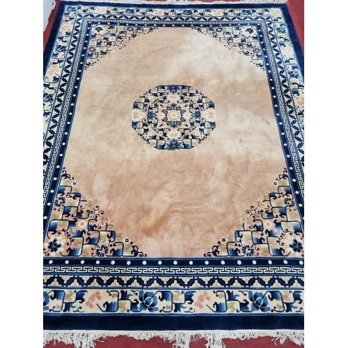 820 - An Oriental Carpet with Cream ground and Blue border, 325cm x 245cm approx.