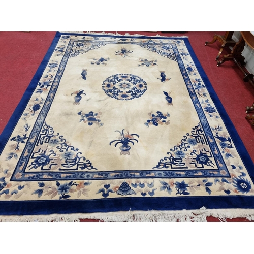 825 - A very large blue and cream ground Oriental Carpet with Greek key style detail. 370 x 280 cm approx.
