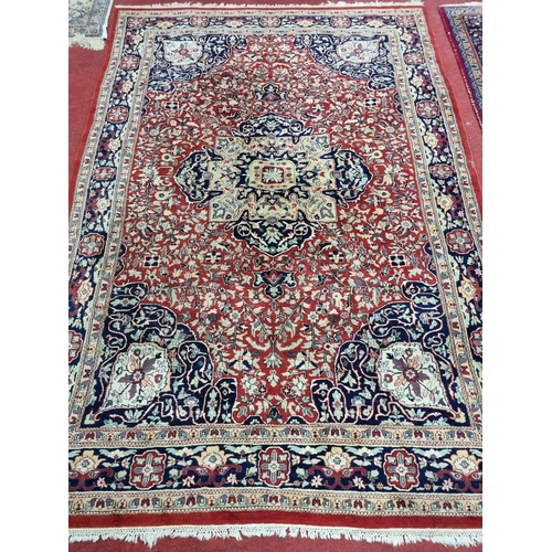 846 - An Iranian red ground Carpet with allover decoration and multi borders. 303 x 203 cm approx.