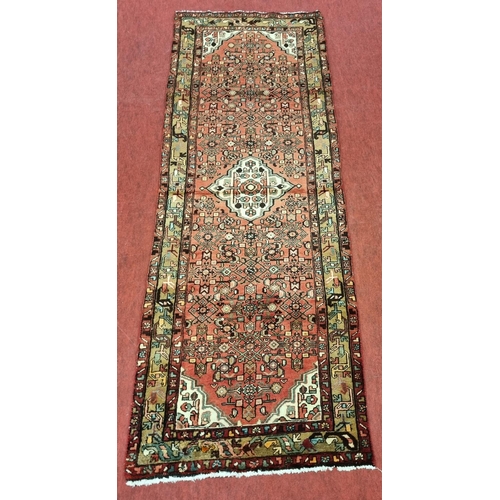 847 - A Red ground washed full pile Persian Hamadan Runner. 296 x 107 cms approx.