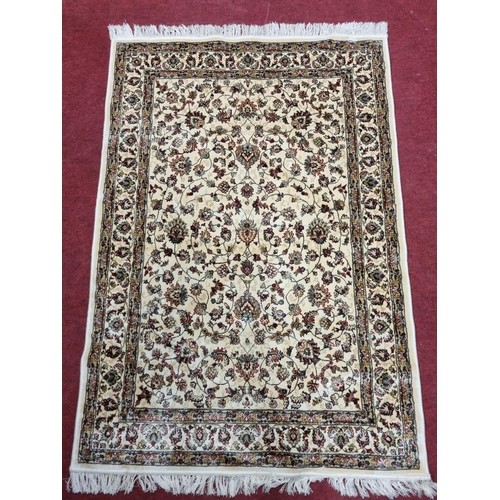 845 - An Ivory ground Cashmere style Rug. 180 x 118 cm approx.