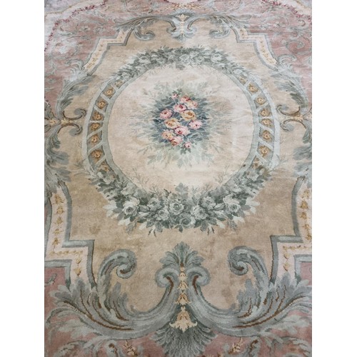 850 - A Large Aubusson style cream and green ground Carpet with central floral motif surrounded by floral ... 