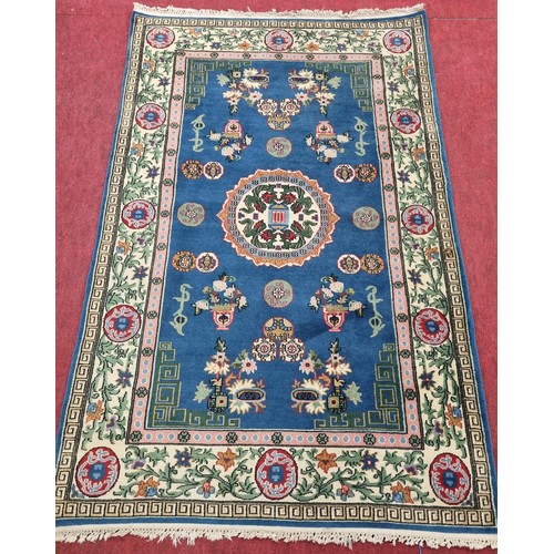 854 - A really good Blue ground Rug with multi borders and Greek quay outer border. 200 x 125 cms approx.