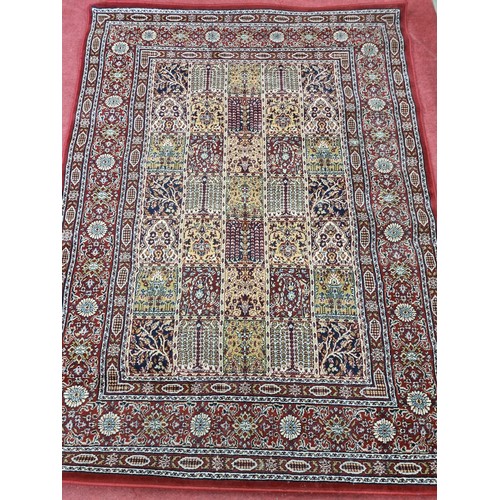 843 - A red ground Rug with multi borders and all over decoration. 230 x 170 cm approx.