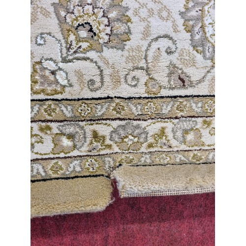 830 - A large Belgium cream ground Carpet with all over decoration and multi borders. 330 x 240 cms approx... 
