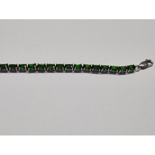 331 - A Gem set Tennis Bracelet set in Silver. 19cms approx long.