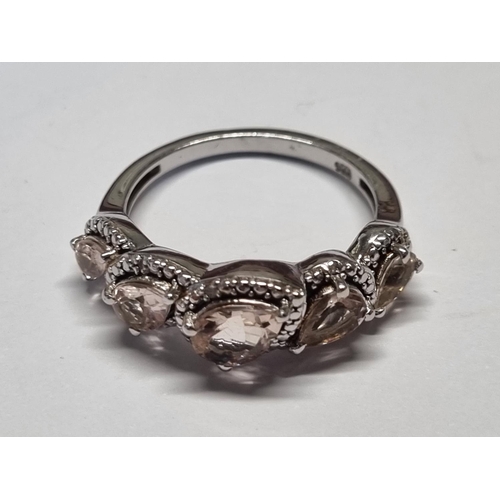 394 - A Gem set Ring set in Silver. Ring size R.