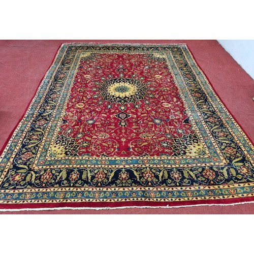 212 - A large red ground Persian Marshad Carpet with a Lozenge and medallion Shah Saffy design. 390 x 290 ... 