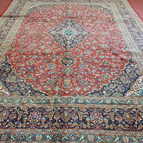 253 - A rich Red ground Persian Kashan Carpet with traditional Kashan medallion design. 380 x 292cm approx... 