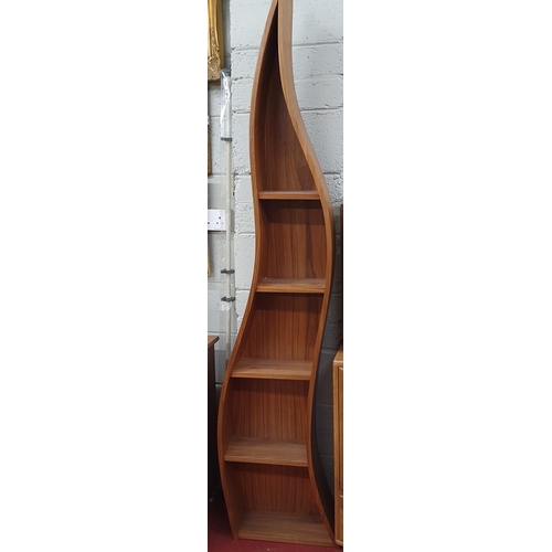 73 - A Walnut Veneered Bookshelves of free flowing form. As new. Height 199 cm approx.