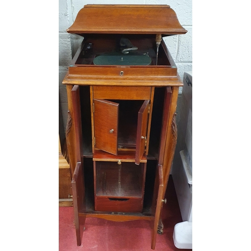 100 - An extremely large early 20th Century Gramophone in a mahogany case along with a large quantity of 7... 