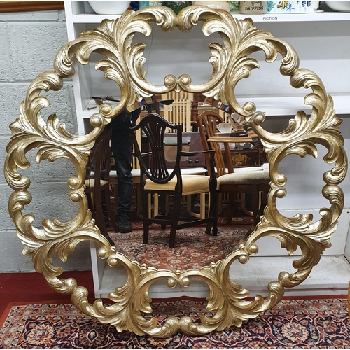 111 - An as new circular highly pierced silvered Mirror with bevelled glass. D 123 cm approx.