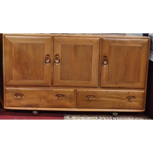 91 - A three door Ercol mid 20th Century Ash Cabinet. 120 x 48 x H 76 cm approx.