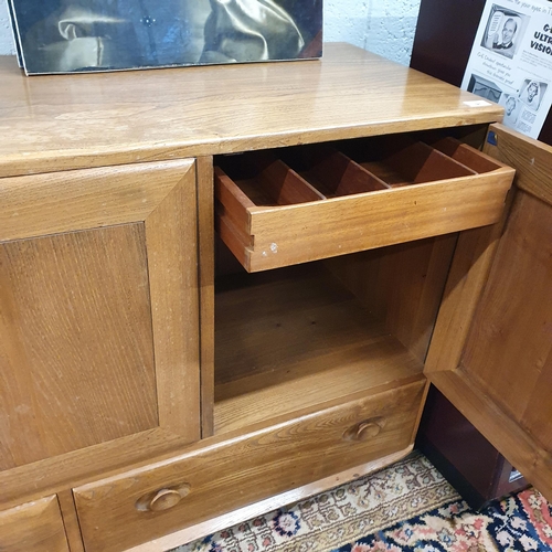 91 - A three door Ercol mid 20th Century Ash Cabinet. 120 x 48 x H 76 cm approx.