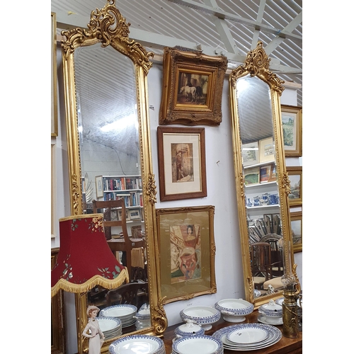 403 - A Fabulous pair of timber gilt pier Mirrors with molded surrounds and carved pediments and beveled g... 