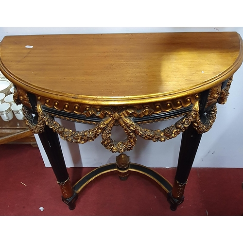 500 - A French half moon Side Table on turned supports with gold and ebony decoration. 84 x 36 x H 80 cm a... 