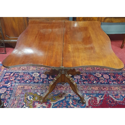 726 - A Victorian Mahogany Tea Table with a serpentine fold-over top and sabre legs. Circa 1860. 
H 76 x L... 