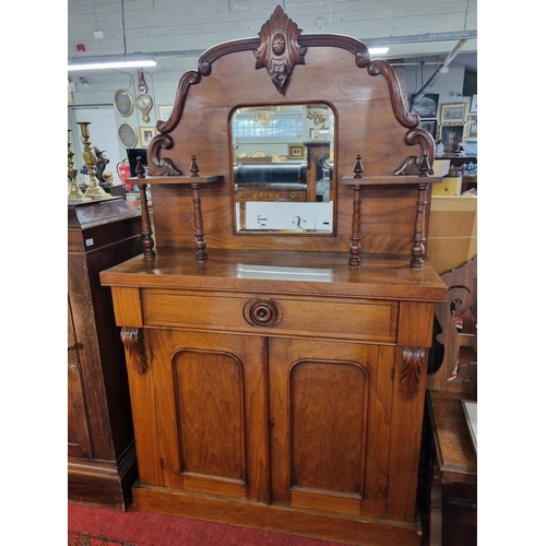 1040 - A 19th Century Mahogany two door Cabinet with mirrored gallery back.