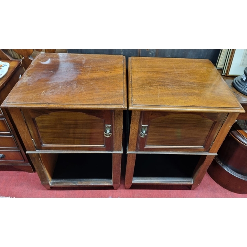 1051 - Pair of bedside Pot Cupboards, with arched panelled doors over an open lower shelf, 20.5